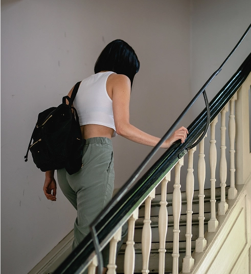 Young Woman walking upstairs.